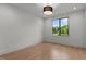 Bright bedroom with light wood floors and large window offering a picturesque view of lush greenery at 949 Harrison Ridge Rd, Wake Forest, NC 27587