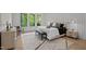 Modern bedroom featuring three large windows, a stylish rug, and ambient lighting at 949 Harrison Ridge Rd, Wake Forest, NC 27587