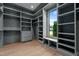 Spacious walk-in closet featuring custom shelves and drawers with a window seat at 949 Harrison Ridge Rd, Wake Forest, NC 27587