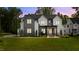 Striking two-story home featuring a modern design, manicured lawn, and stylish landscaping at 949 Harrison Ridge Rd, Wake Forest, NC 27587