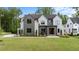 Beautiful modern two-story home with lush green lawn, professional landscaping, and stylish curb appeal at 949 Harrison Ridge Rd, Wake Forest, NC 27587