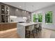 Modern kitchen featuring stainless steel appliances, a marble waterfall island, and ample natural light at 949 Harrison Ridge Rd, Wake Forest, NC 27587