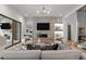 Bright living room with a stone fireplace, a modern chandelier, and hardwood flooring at 949 Harrison Ridge Rd, Wake Forest, NC 27587