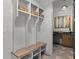 Functional mudroom with built-in bench, cubbies, basket storage, and stylish tile flooring at 949 Harrison Ridge Rd, Wake Forest, NC 27587