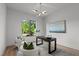 Bright home office features a modern desk, accent chairs, and a picturesque window view at 949 Harrison Ridge Rd, Wake Forest, NC 27587