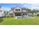 Rear view of home with a backyard pool, patio, and built in grill surrounded by green grass at 949 Harrison Ridge Rd, Wake Forest, NC 27587