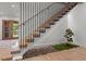 Modern staircase with wooden steps, black railing, and Zen garden underneath at 949 Harrison Ridge Rd, Wake Forest, NC 27587