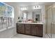 Bathroom features a large vanity with dark wood cabinets, dual sinks, and large windows at 987 Parkstone Towne Blvd, Knightdale, NC 27545