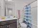 Bathroom features a vanity with dark wood cabinets, a toilet, and a shower/tub with curtain at 987 Parkstone Towne Blvd, Knightdale, NC 27545