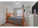 Bedroom featuring a four-poster bed, neutral walls, and natural light at 987 Parkstone Towne Blvd, Knightdale, NC 27545