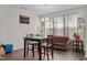 Bright dining area featuring a dark wood table set, large windows, and wood-look flooring at 987 Parkstone Towne Blvd, Knightdale, NC 27545