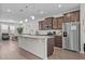 Spacious kitchen features a large island, granite countertops, stainless steel appliances, and wood-look flooring at 987 Parkstone Towne Blvd, Knightdale, NC 27545