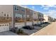 Rear exterior view of modern townhomes with balconies, garages, and private parking spaces at 987 Parkstone Towne Blvd, Knightdale, NC 27545