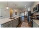 Well-equipped kitchen featuring an island with stainless steel appliances and stylish pendant lights at Lot 5 Cooper St, Sanford, NC 27330
