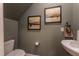 This cozy powder room features olive-green walls, modern fixtures, and tasteful decor at Lot 5 Cooper St, Sanford, NC 27330
