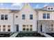 Charming new construction townhome with white siding and manicured landscaping at Lot 6 Cooper St, Sanford, NC 27330