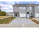 Townhome with gray siding, a one-car garage, and a concrete driveway and entrance at Lot 6 Cooper St, Sanford, NC 27330