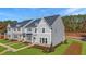 New construction townhomes with siding, landscaping, and multiple windows at Lot 6 Cooper St, Sanford, NC 27330