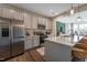 Modern kitchen featuring stainless steel appliances, gray cabinets, and a spacious island at Lot 6 Cooper St, Sanford, NC 27330
