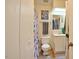 Compact bathroom with a shower, toilet, vanity and natural light from a skylight at 10 Grove Park Rd, Durham, NC 27705