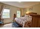 Inviting bedroom with a cozy atmosphere, windows, warm neutral walls, and soft natural light at 10 Grove Park Rd, Durham, NC 27705