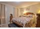Bright bedroom with windows, neutral walls, wooden furniture and a comfortable queen size bed at 10 Grove Park Rd, Durham, NC 27705