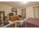 Bedroom with warm neutral walls, natural light, bed, chair, dresser, and desk at 10 Grove Park Rd, Durham, NC 27705