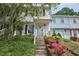 Townhouse exterior showing covered entrance, wreath on the door and colorful landscaping at 10 Grove Park Rd, Durham, NC 27705