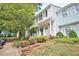 Townhouse exterior showing the covered entrance, colorful landscaping, and a glimpse of the neighboring unit at 10 Grove Park Rd, Durham, NC 27705
