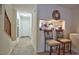 Hallway showcasing carpeted staircase, view to the front door and a view to the kitchen at 10 Grove Park Rd, Durham, NC 27705