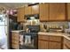 Kitchen featuring wood cabinetry, black electric stove and refrigerator at 10 Grove Park Rd, Durham, NC 27705
