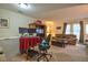 Spacious living room area featuring a TV, cabinet, comfortable seating and natural light at 10 Grove Park Rd, Durham, NC 27705