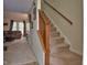 Living area featuring carpeted staircase, and a glimpse of the backyard at 10 Grove Park Rd, Durham, NC 27705