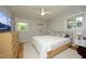 Well-lit bedroom features a ceiling fan and serene views from two windows at 1004 Greenwich St, Raleigh, NC 27610