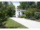 A long driveway leads to a well-maintained home surrounded by lush greenery at 1004 Greenwich St, Raleigh, NC 27610