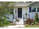 Charming front entrance with black door and manicured landscaping at 1004 Greenwich St, Raleigh, NC 27610