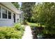 Charming home with a landscaped pathway leading to the inviting front entrance at 1004 Greenwich St, Raleigh, NC 27610