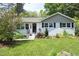 Charming single-story home with black shutters, landscaped front yard, and inviting entrance at 1004 Greenwich St, Raleigh, NC 27610