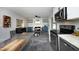 Updated kitchen transitions into dining space with modern fireplace and gray flooring at 1004 Greenwich St, Raleigh, NC 27610