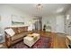 Open-concept living room with hardwood floors, neutral walls, and seamless flow to kitchen at 1004 Greenwich St, Raleigh, NC 27610