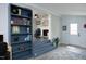 Cozy living room with blue bookcase with view of dining room and fireplace at 1004 Greenwich St, Raleigh, NC 27610