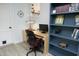 Comfortable office with built in blue bookcase and gray flooring at 1004 Greenwich St, Raleigh, NC 27610