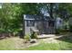 Well-maintained backyard storage shed with windows and adjacent garden area at 1004 Greenwich St, Raleigh, NC 27610