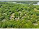 A high angle shows the community near a river surrounded by many lush green trees on a sunny day at 101 Abbotsford Ct, Durham, NC 27712