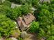 Stunning aerial view of a home featuring mature trees and a brown shingled roof at 101 Abbotsford Ct, Durham, NC 27712