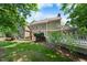 Exterior view of the house with a large deck and well-maintained lawn, perfect for outdoor living at 101 Abbotsford Ct, Durham, NC 27712