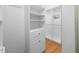 Walk-in closet featuring built-in shelving, drawers, and hanging rods for optimal storage at 101 Abbotsford Ct, Durham, NC 27712