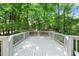 Spacious white wooden deck surrounded by mature trees, perfect for outdoor relaxation at 101 Abbotsford Ct, Durham, NC 27712
