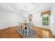 Dining room is bright, features wainscoting, hardwood floors, and elegant lighting at 101 Abbotsford Ct, Durham, NC 27712