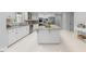 Bright, open kitchen with an island, white cabinets, granite countertops, and stainless steel appliances at 101 Abbotsford Ct, Durham, NC 27712